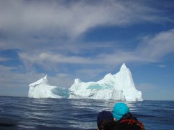 Monumental iceberg with people