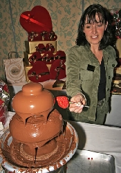 Icewine festival at Sun Peaks. Coating strawberries at chocolate display during progressive tasting night. Sun Peaks, BC, Canada. Photo by Yvette Cardozo, www.cardozohirsch.com