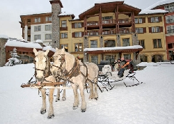 Skiers enjoy a sip of wine and a sleigh ride through the center of Sun Peaks village after skiing at icewine festival, Sun Peaks ski resort, BC, Canada. Photo by Yvette Cardozo, www.cardozohirsch.com
